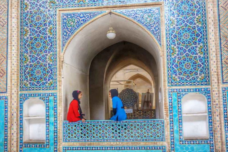 Iranian girls surrounded b beautiful mosaic walls in Iran