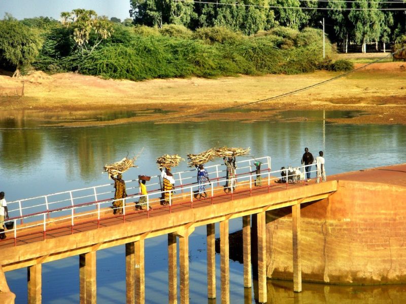 Women carrying firewood across the Bani river