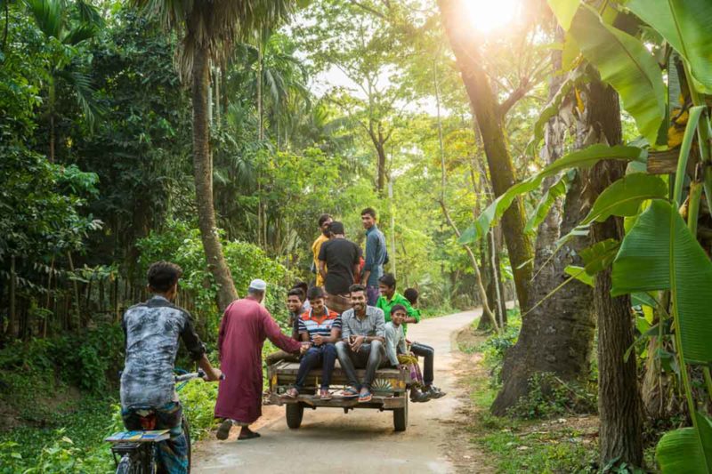 Local boys riding a “van” down the road on the remote island of Monpura, Bangladesh