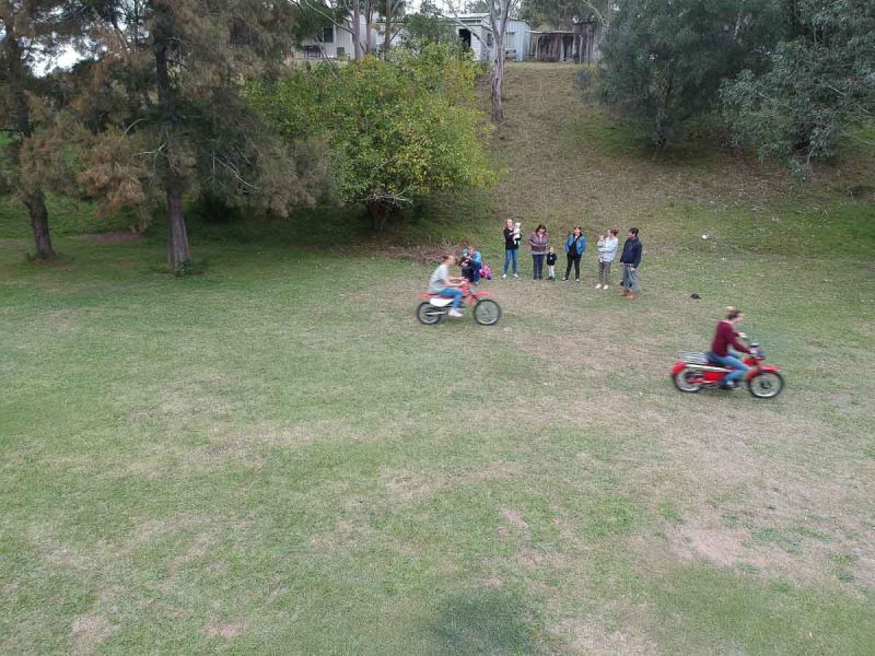 Riding motorbikes around a field at Rosewood, NSW