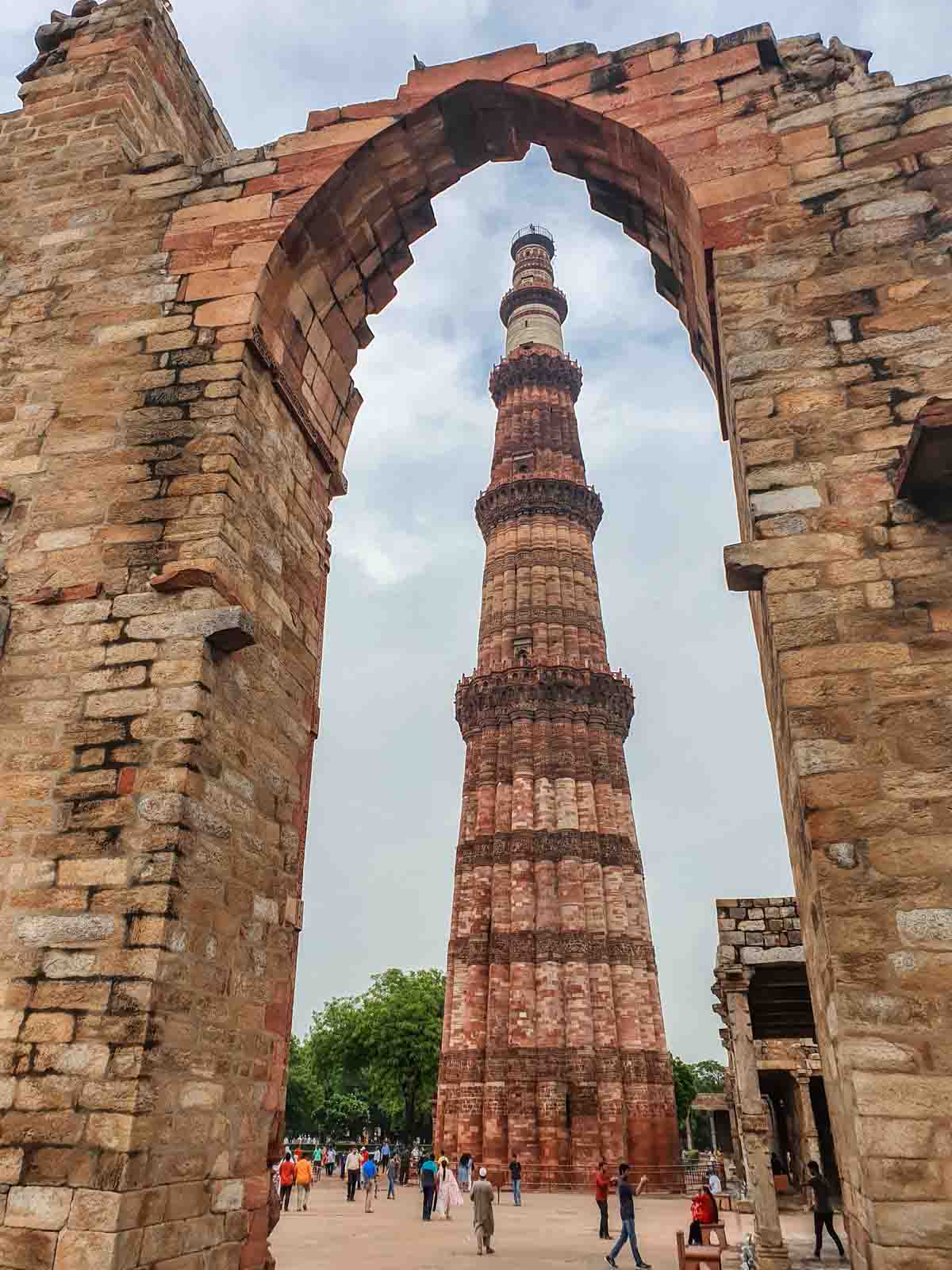 Qutb Minar through one of the arches at the Qutb Minar complex Delhi